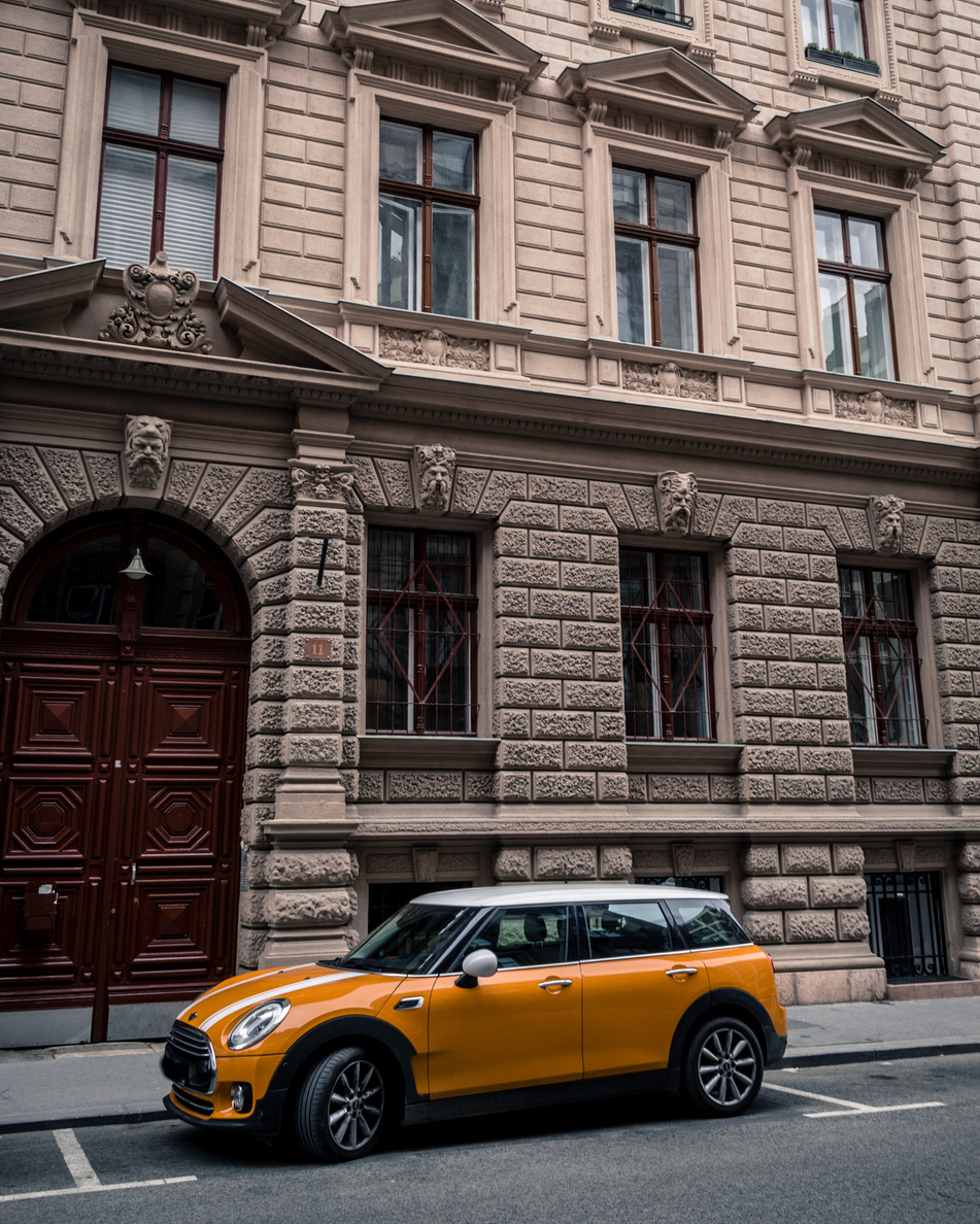 A Mini Cooper Car Parked in Front of a Building